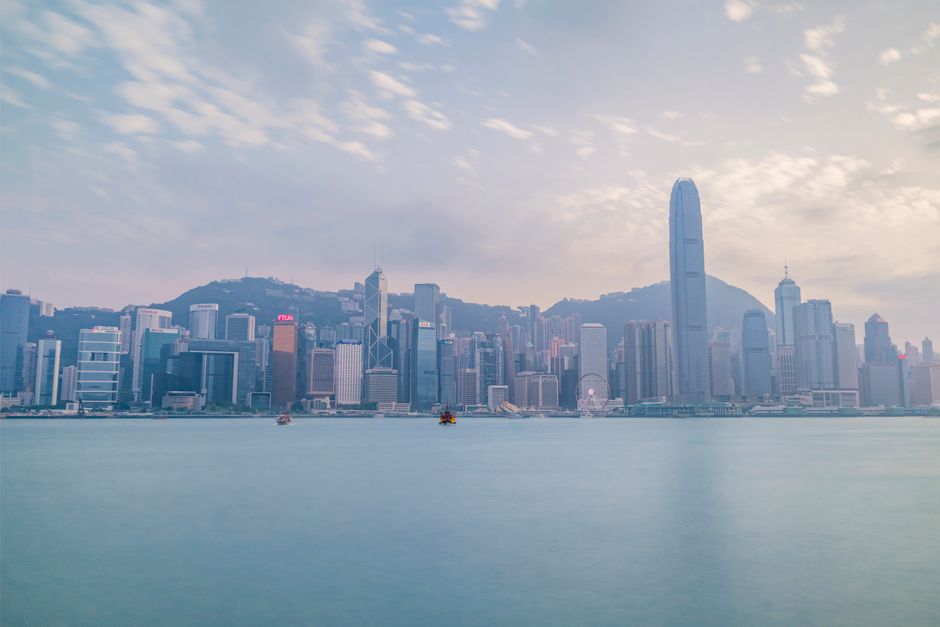 Stunning view of Hong Kong skyline from Victoria Harbour during daylight.