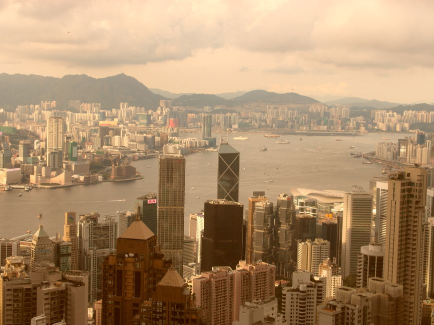 Stunning aerial view of Hong Kong's skyline and Victoria Harbour at daytime.